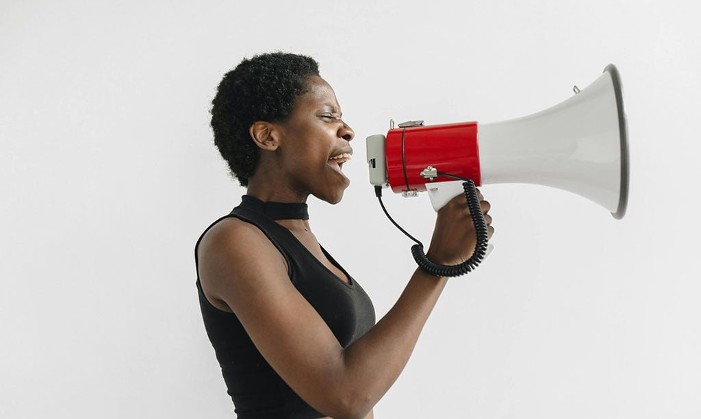 Protestor speaking into megaphone.